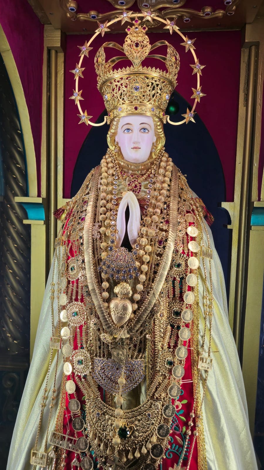 The crowned statue of Vadavai Matha covered in gold offerings on her feast night