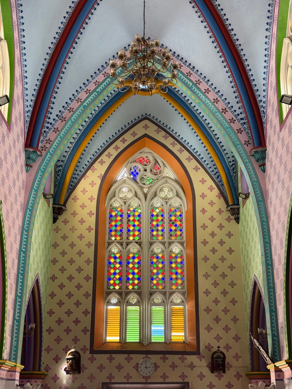 The painted rib vault, chandelier and coloured-glass window inside Holy Family Church, Vadakkankulam